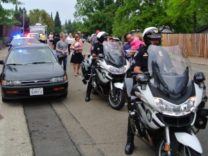Citrus Heights police officers lead a National Night Out parade down Indian River Drive