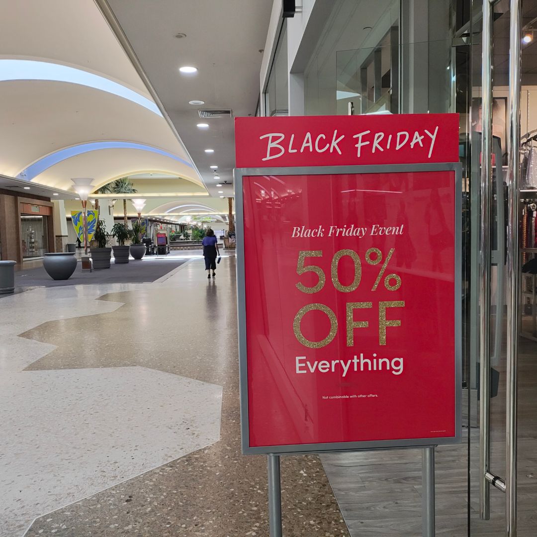 A sign outside Torrid advertising a sale for Black Friday. // SB Williams