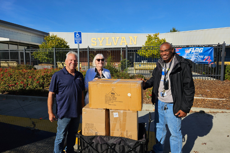 L-R: Mark Duncan- Club Past President, Leah Churchill-Shoe Project Chair, Daren Canaday- Sylvan Middle School Staff