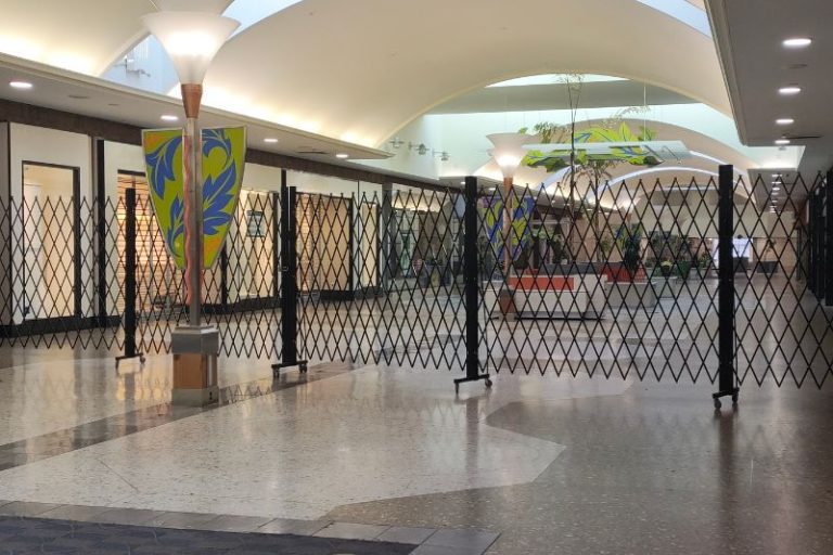 A black collapsable gate has been drawn across the corridor at Sunrise Mall. // SB Williams