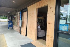 The entrance to Hall's Furniture was framed by plywood Thursday after a vehicle crashed through the store's entrance on Monday. // SB Williams