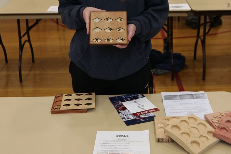 A high school student shows off his designs for a portable tic-tac-toe game during the Sacramento Valley Manufacturers Alliance High School Manufacturing Challenge in 2024 at San Juan High School. // Courtesy of Sacramento Valley Manufacturers Alliance