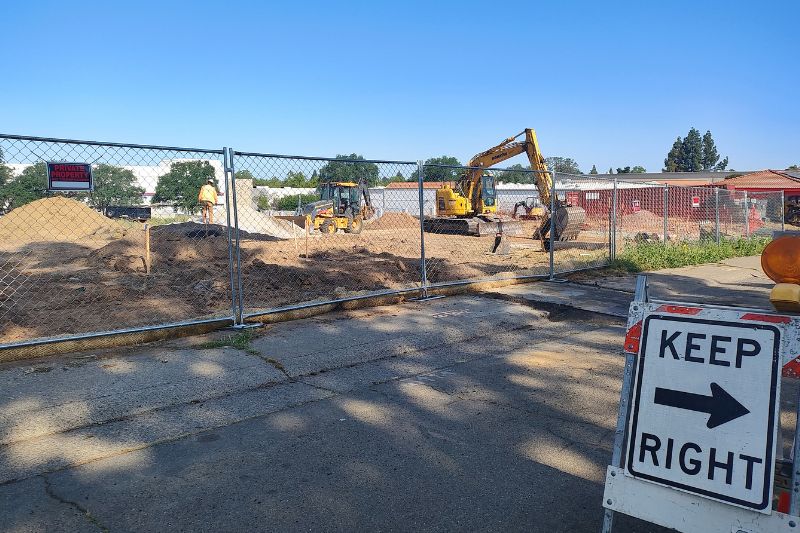 Heavy construction equipment can be seen on the future site of a three-story apartment complex on Sunrise Vista Drive. // SB Williams