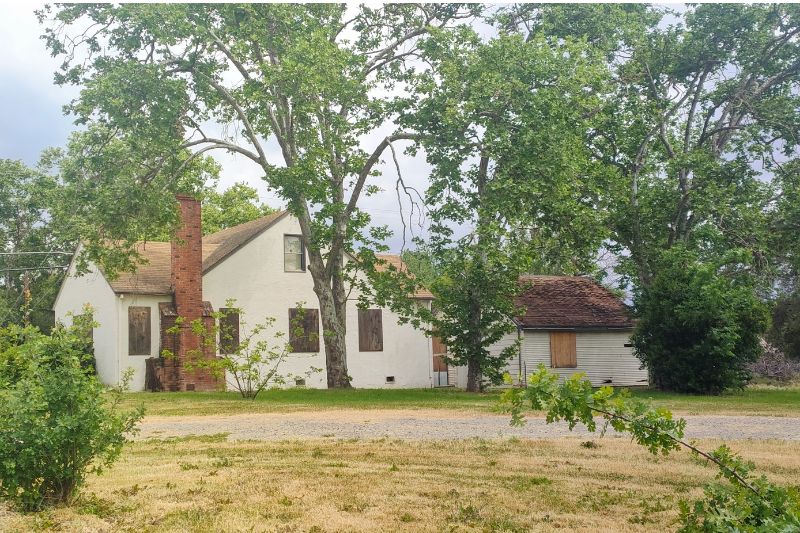 A boarded up home on Watson Way and Mariposa Ave. is listed for sale.