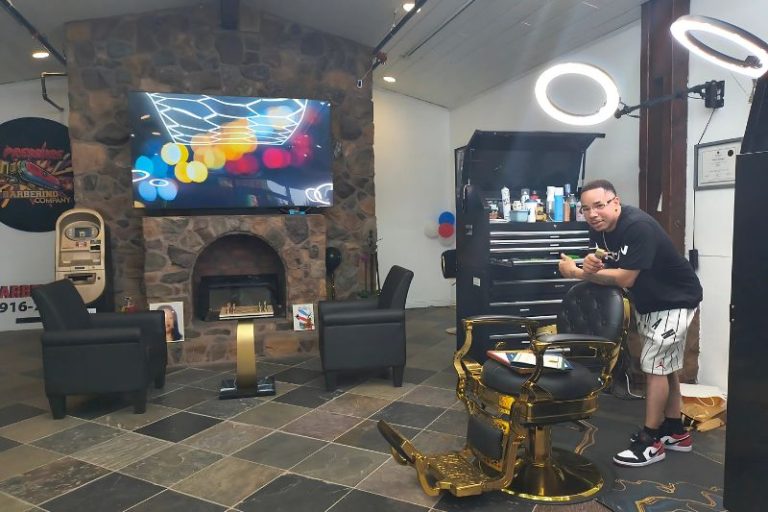 Pressure Barbering Company and Salon owner Nyeron Jefferson stands in his new barbershop which celebrated a ribbon cutting Friday, June 6, 2025. / SB Williams
