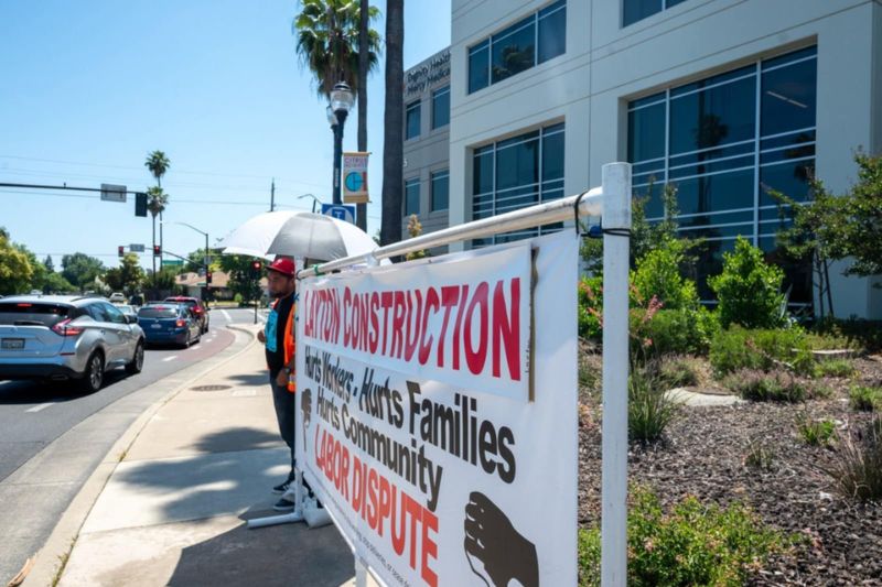 A small group of protesters stood in front of Dignity Health in Citrus Heights, Thursday, June 12, 2025. // Mike Hazlip