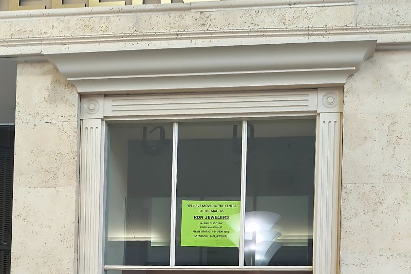 A sign that reads "We have moved in the center as Ron's Jewlers, next to JCPenney." // SB Williams