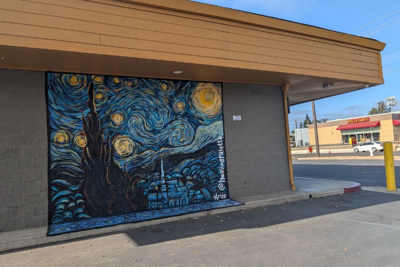A mural painted by artist Amie Nowell, one of many murals that are part of the new CH40 arts district. This small rendition of "Starry Night" is painted on the back of Elite Bicycles. // SB Williams