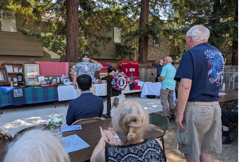 US Army veteran Geno Bartucco leads other vets in a final salute to "Mom" during a memorial service for Jeanne Rounsavell at the Veterans Community Center, Sept. 27. 2025. // SB Williams