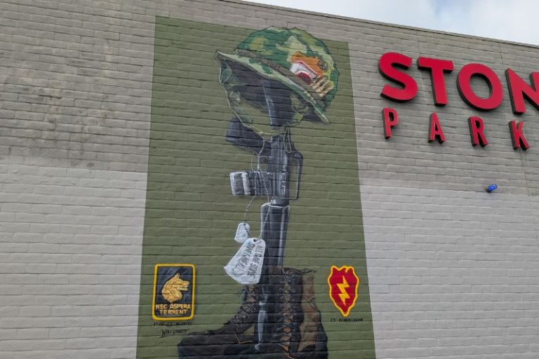 A veteran-themed mural graces the wall of Stones Gambling Hall's parking garage. // SB Williams